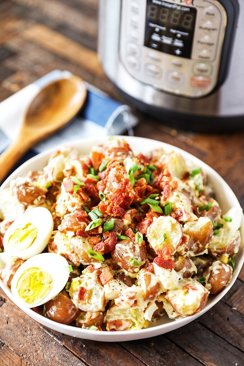 Bowl of potato salad mixed with bacon and hard boiled eggs