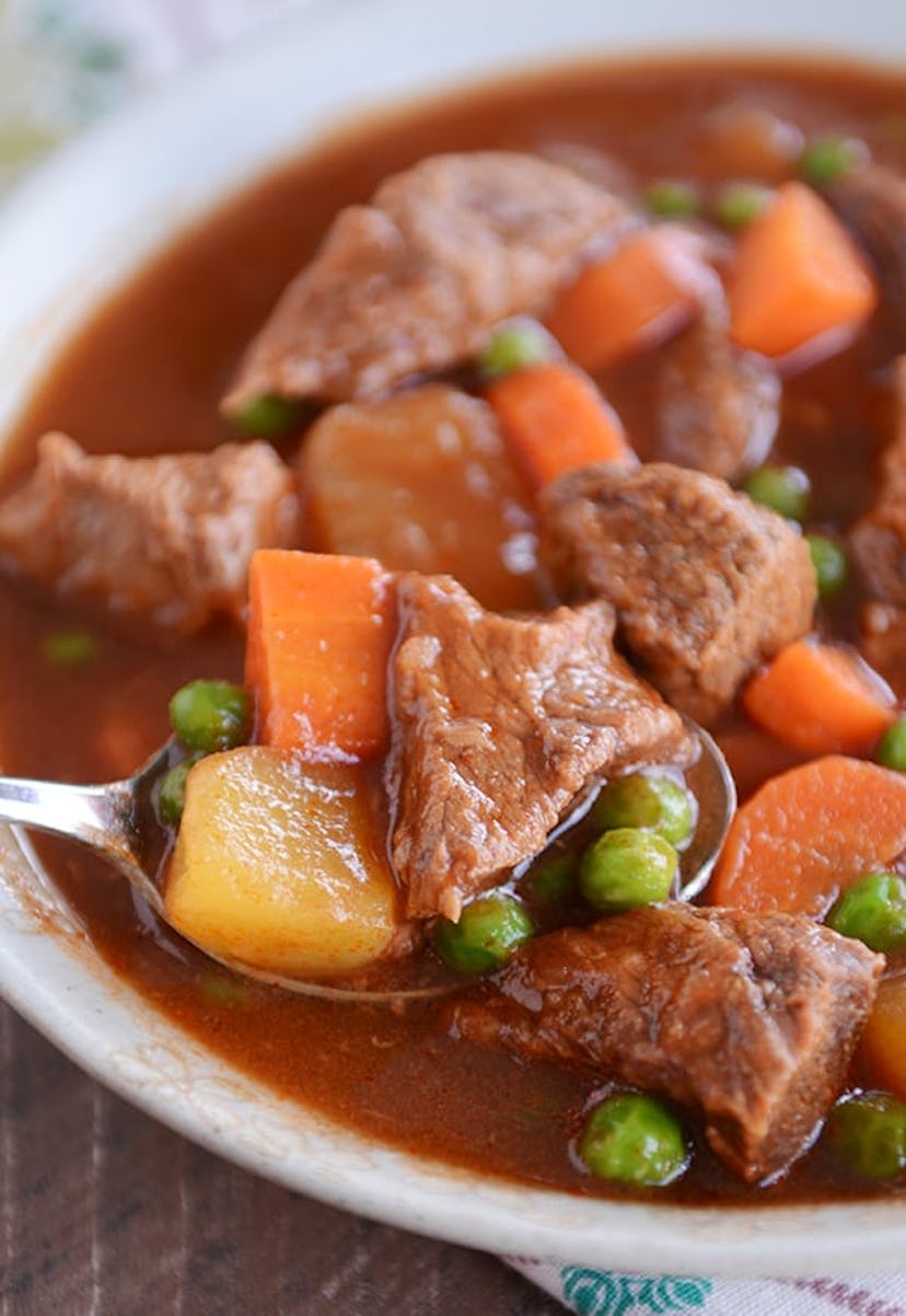 Close up of spoon scooping beef stew