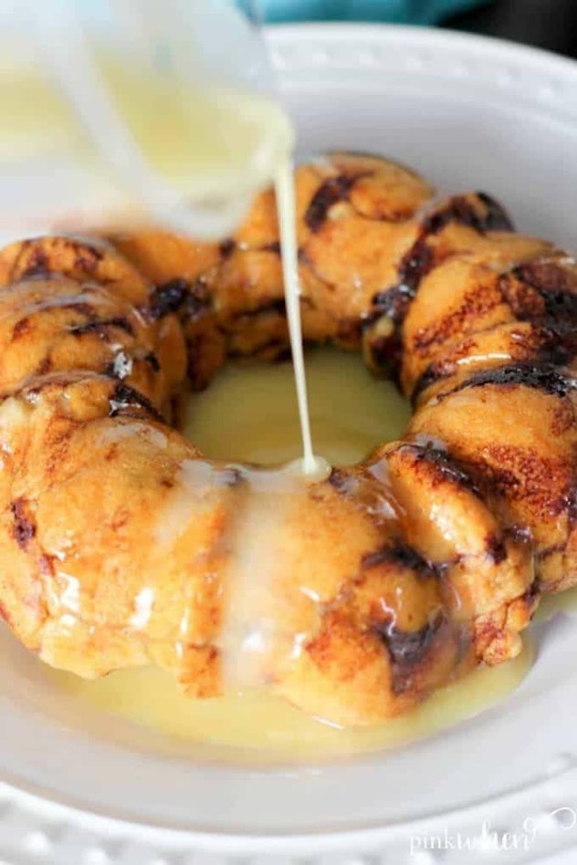 ring monkey bread with icing being poured on