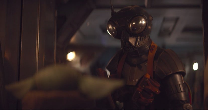 The droid Zero approaches Baby Yoda in The Mandalorian