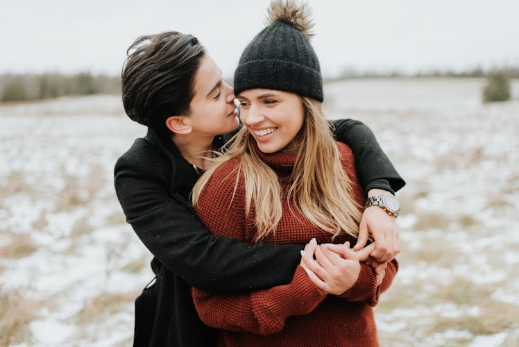 Female couple cuddling in winter for romantic season