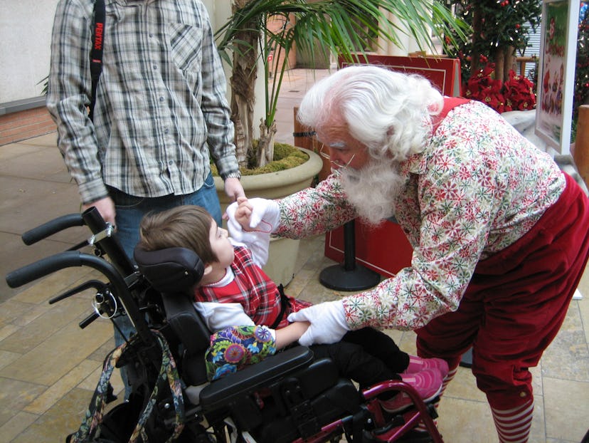 Santas interact with children with autism and special needs at Santa Cares events 