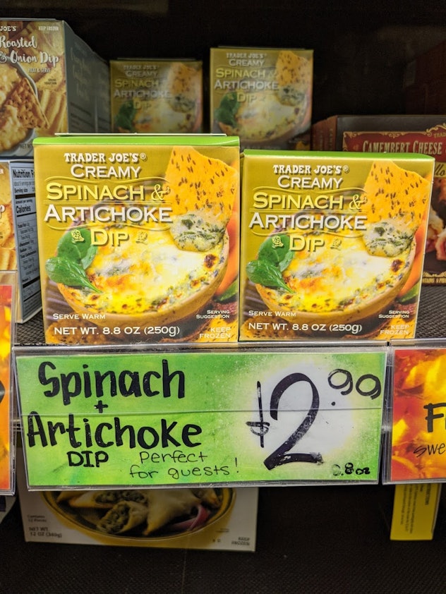 Trader Joe's display of packed, pre-made, frozen spinach & artichoke dip