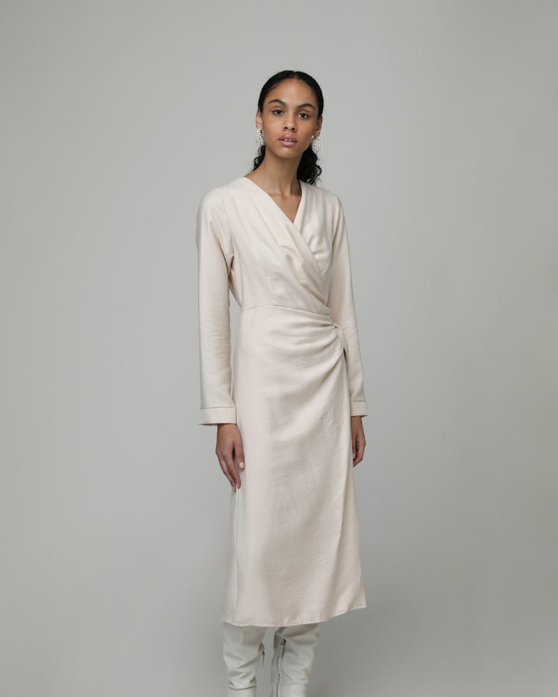 A model wearing a white midi dress from Oak + Fort