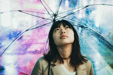 Young Asian woman in the rain during Capricorn season 2019.