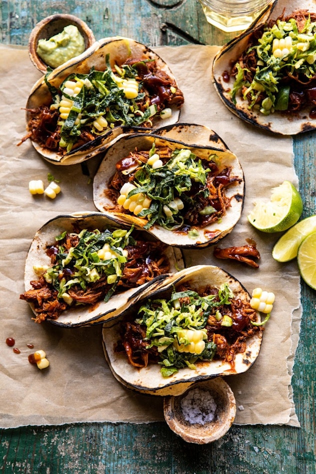 open faced tacos with shredded chicken, lettuce, and corn