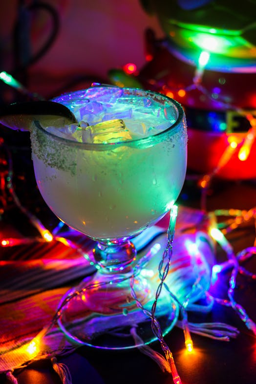 The glow margarita surrounded by Christmas lights is part of the "Let It Glow"-inspired cocktails av...
