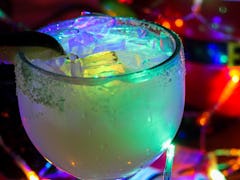 The Glow Margarita surrounded by Christmas lights is available at Disney for the "Let It Glow" festi...