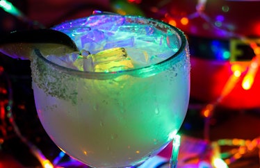The Glow Margarita surrounded by Christmas lights is available at Disney for the "Let It Glow" festi...