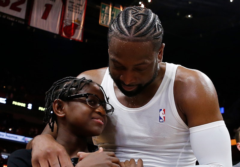 Dwyane Wade hugs Zion Wade after his final NBA career home game in April 2019 in Miami, Florida