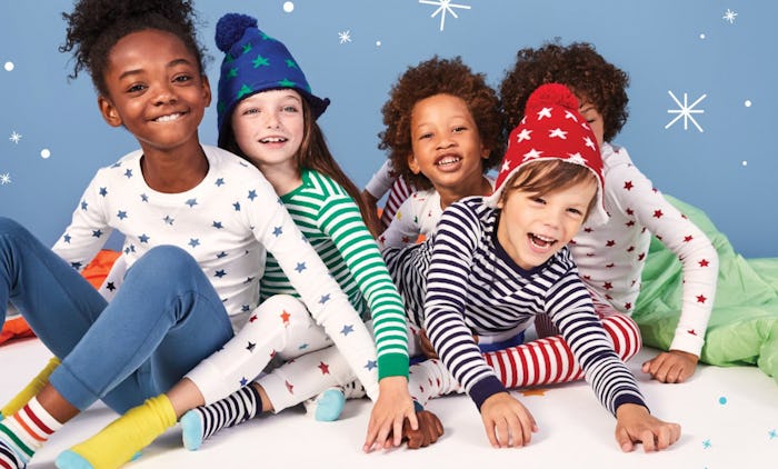 Primary promotional photo featuring five kids wearing an assortment of primary socks, pants, tops, a...