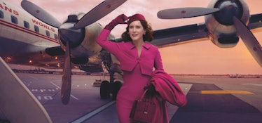 'The Marvelous Mrs. Maisel' Rachel Brosnahan stands on an airplane runway dressed in pink.