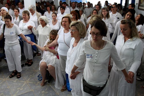 People pray together to prepare for a healing session at the "Casa de Dom Inacio de Loyola" in Abadi...