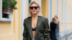 Aylin Koenig is seen weairng white Dior bag, midi skirt, bra, olive blazer outside Boss during Milan...
