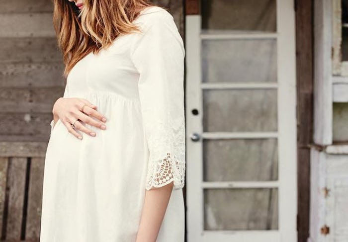 a pregnant woman wearing a dress from Ingrid & isabel