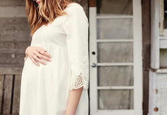 a pregnant woman wearing a dress from Ingrid & isabel