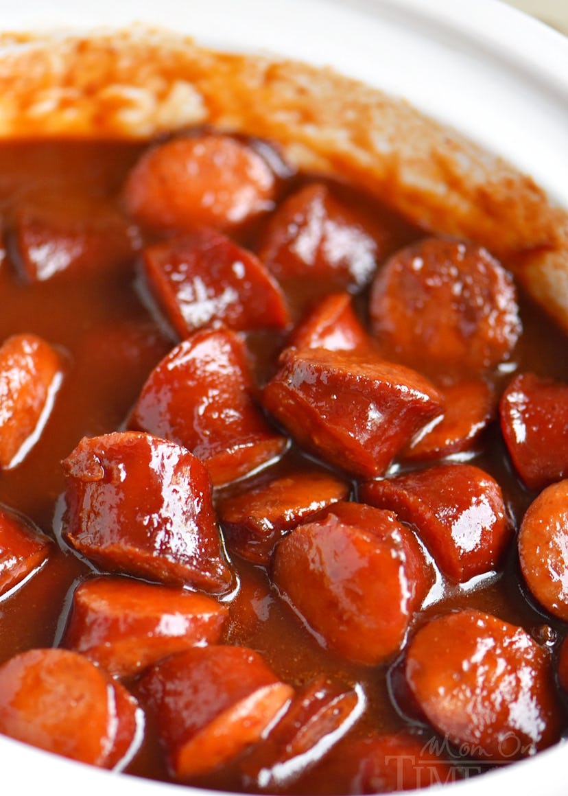 Glossy kielbasa cut up into bite-size pieces in sauce