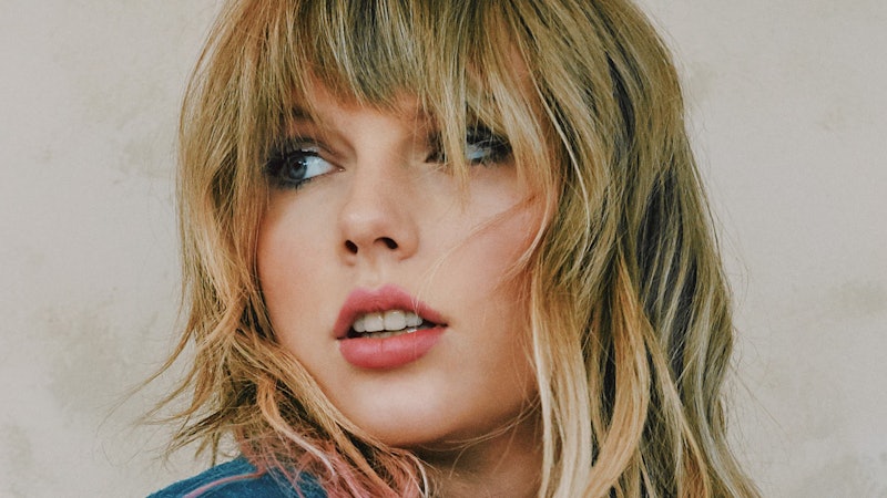 Taylor Swift with her long blonde hair and bangs looking on the side