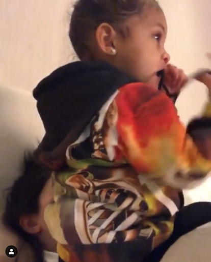 Kylie Jenner's daughter Stormi uses her as a chair while she watches television.