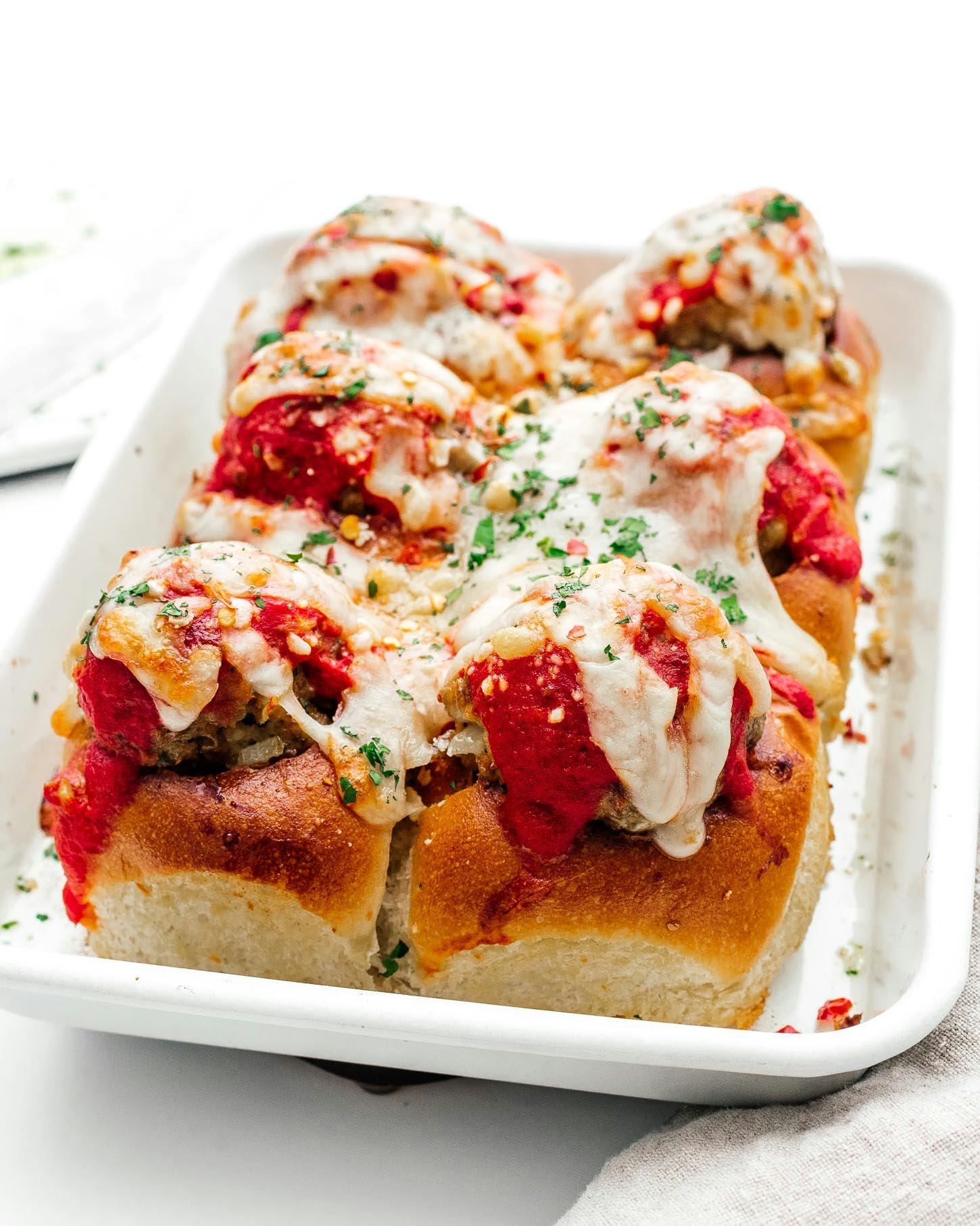 Meatball sliders on a platter, made on a sheet pan