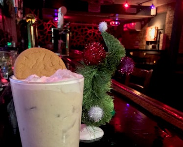 A 'Grinch'-inspired Gingerbread White Russian cocktail sits on the bar of the East Village Tavern wi...