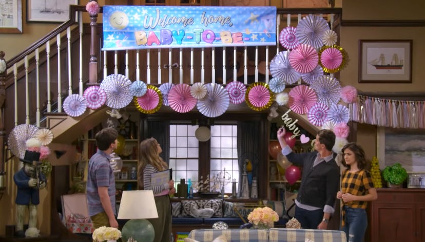 D.J. and family look at the Baby-To-Be-Named-Later banner in Fuller House