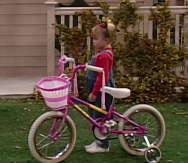 Michelle with her pink bike on Full House