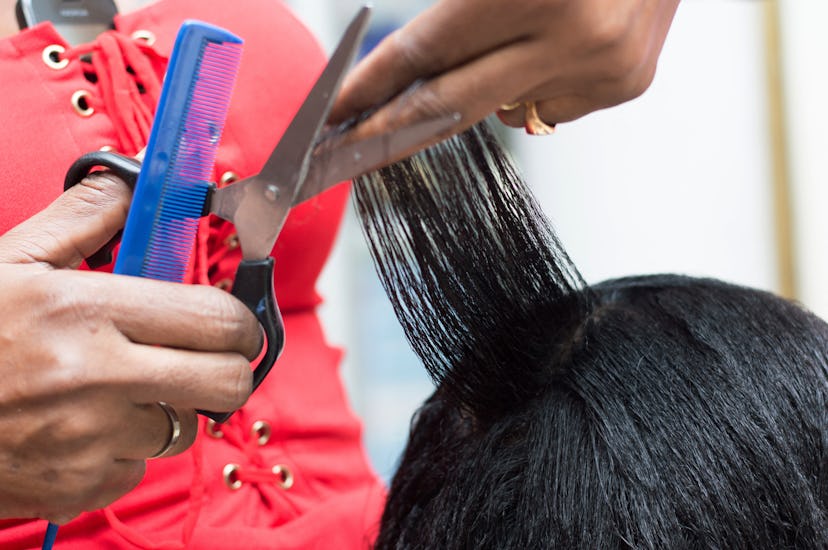 A person gets her hair done in a salon. The chemicals from hair relaxers and permanent dyes may cont...