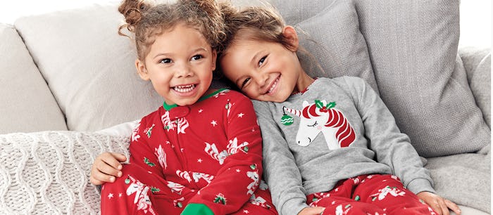 two little girls wearing holiday pajamas from Carter's