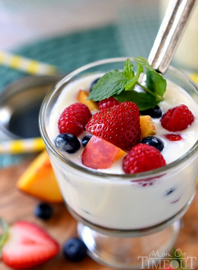 parfait bowl of yogurt with an assortment of fruit on top 