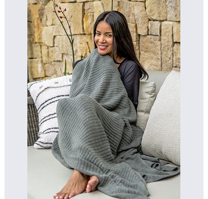 The Barefoot Dreams blanket *does* look as cozy as Chrissy Teigen says it is.