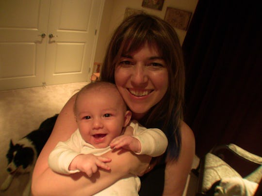 Mom holding baby and smiling