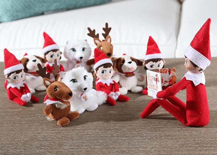 Elf on the Shelf reading a mini version of the 'Elf on the Shelf' book to mini stuffed animals