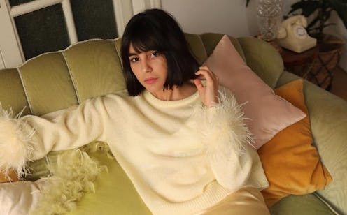Maria Bernad in a white sweater with feathers and a satin skirt, one of Spring's biggest fashion tre...