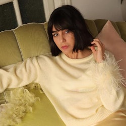 Maria Bernad in a white sweater with feathers and a satin skirt, one of Spring's biggest fashion tre...