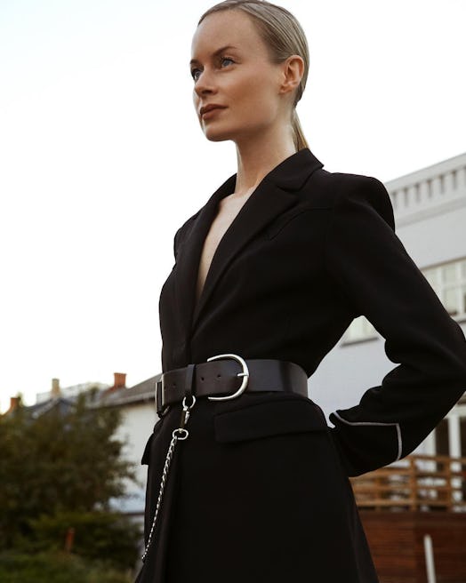 Thora posing in a black belted blazer