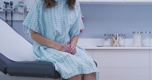 A woman with HPV sitting on a hospital bed