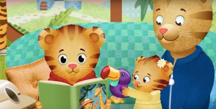 An insert from Daniel Tiger, with one tiger reading while the other plays with a toy and the third s...