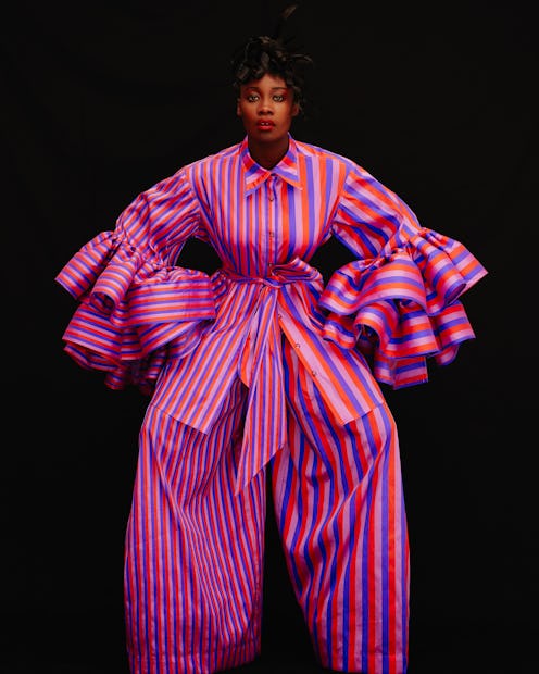 A model wearing a striped red white and purple suit that looks like gift wrapping at the NYFW 