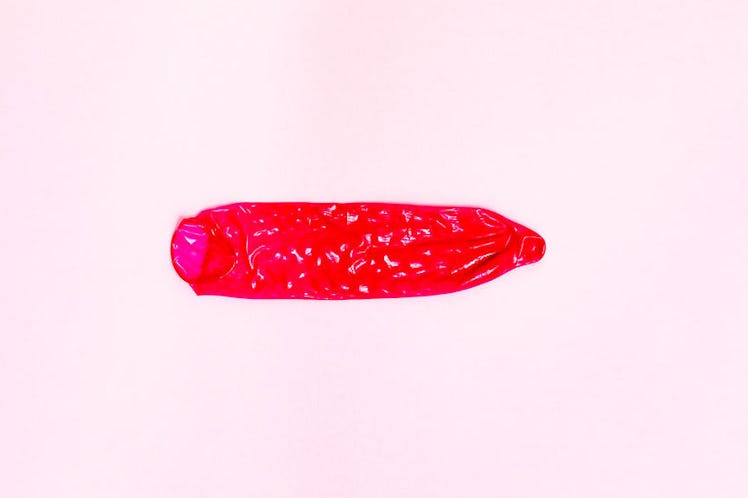 Rolled-out red condom