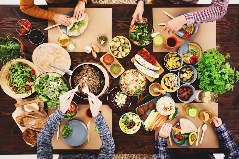 Four friends share a vegan meal. Going vegan without hurting your health is very possible, doctors s...