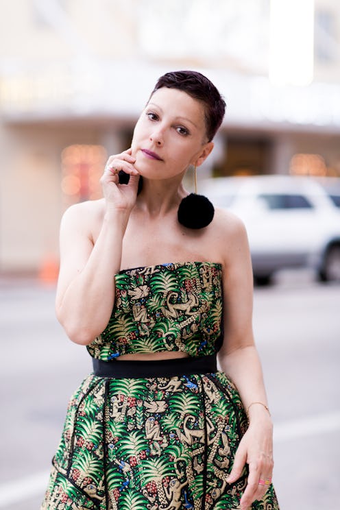 Angeles Almuna with short black hairstyle posing in a green dress