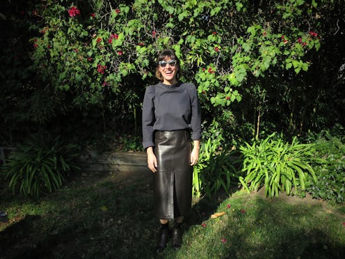 Gallery Director Christine Messineo in sunglasses a black top and leather pants walking through a fo...