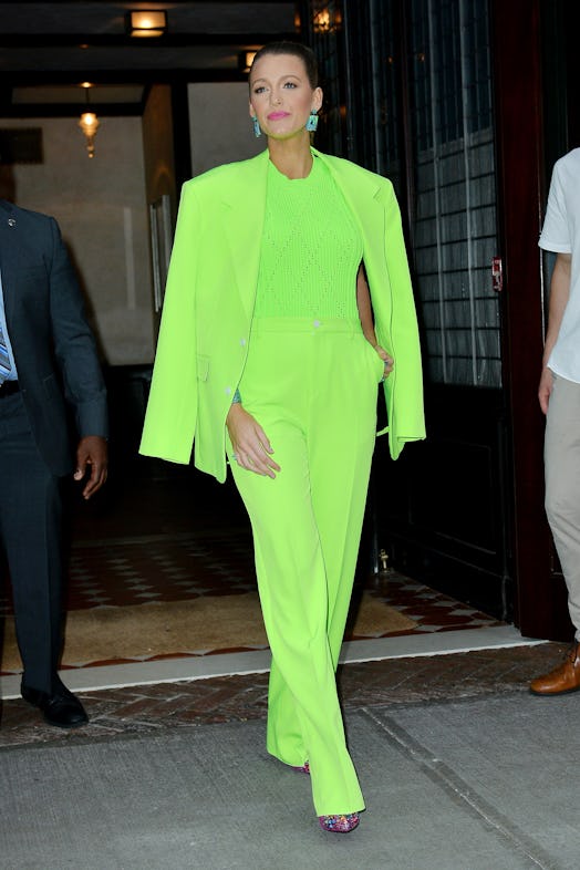 A female model walking in a slime green overall