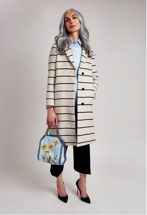 Pam Lucas posing for a photo in a white coat