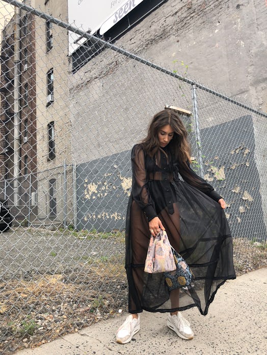 Lauren Caruso posing in a long black see-through dress
