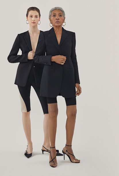 Two girls posing in black short leggings and in black blazers