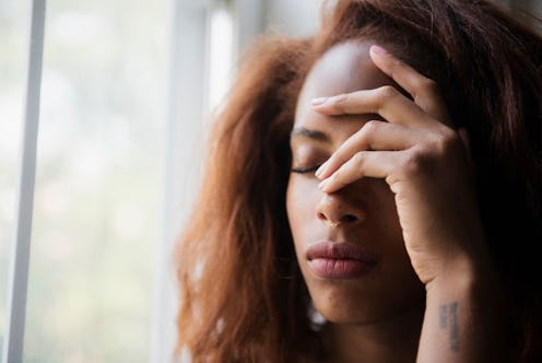 A woman experiencing a chronic headache