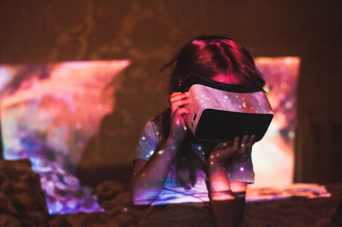 a little girl looking at the stars through a viewfinder