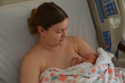 A newborn baby sleeping in the mother arms while in hospital